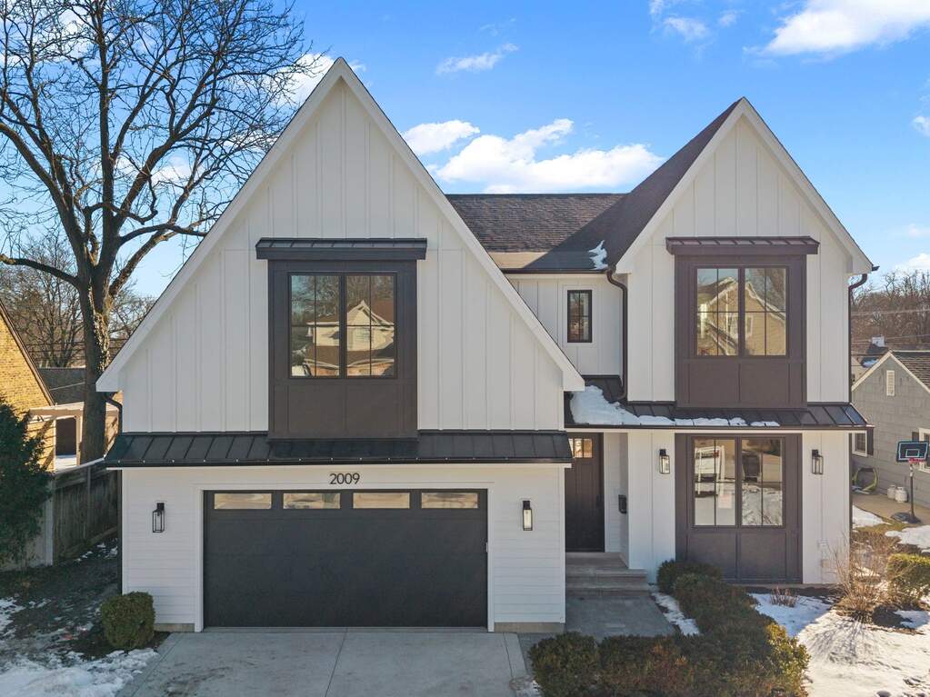 Modern two-story house with gabled roof.