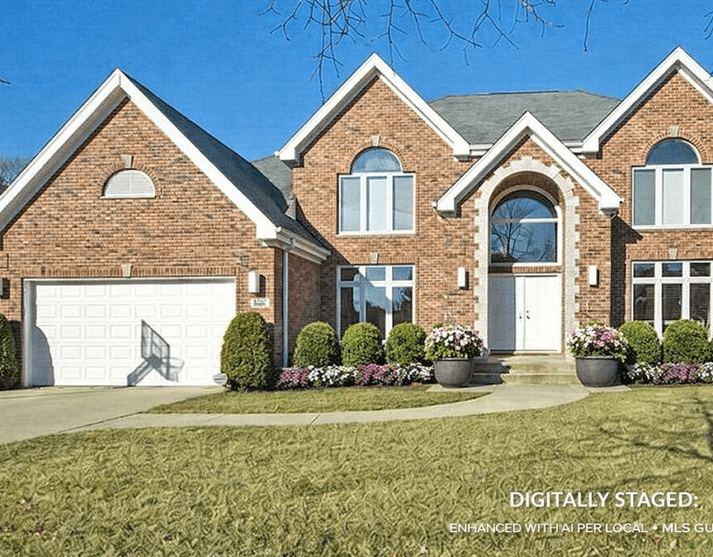 Brick house with arched windows and driveway.
