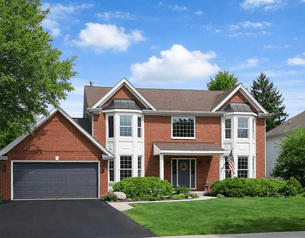 Red brick house with blue sky background.