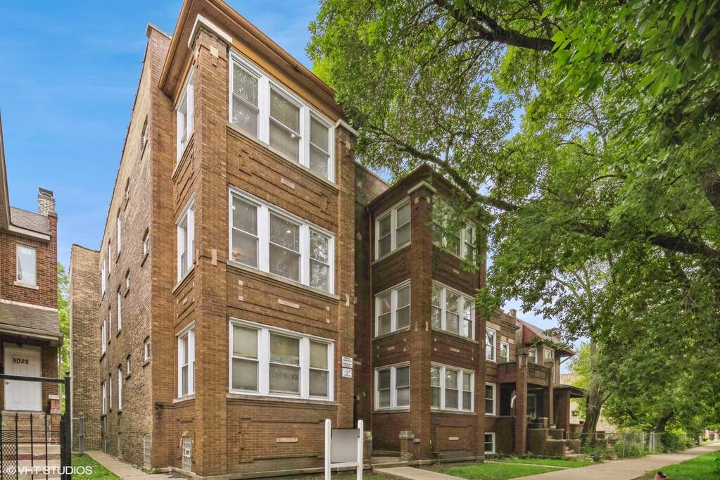 Brick apartment buildings with large windows.