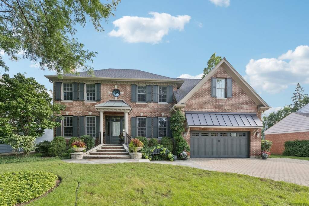Two-story brick house with attached garage.