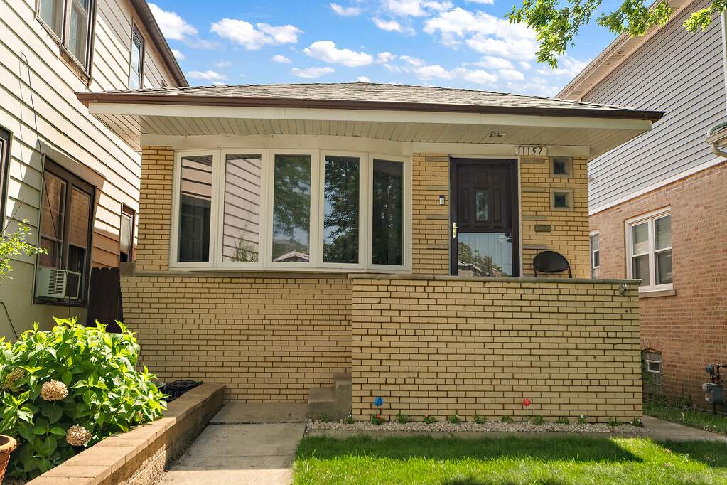 Single-story brick house with front yard.