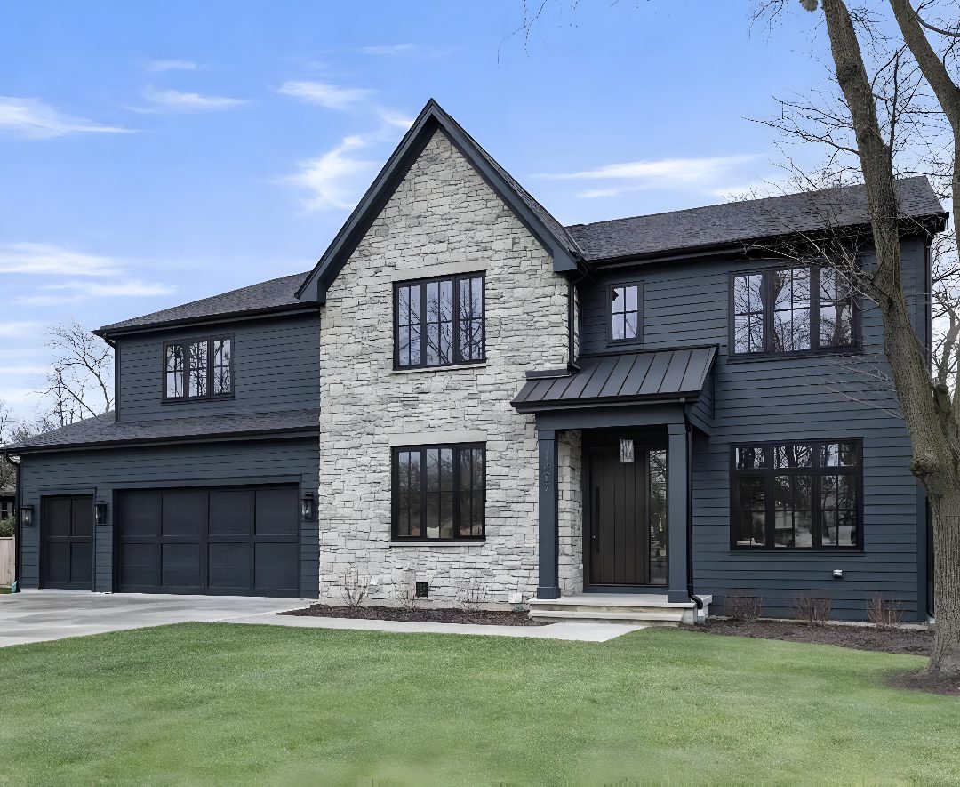 Modern two-story house with stone facade.